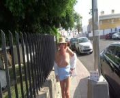 Mature woman exposed on the street from naked woman walking on the city street in the early morning public
