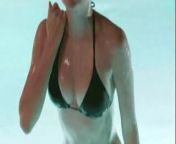 Maia Mitchell emerging from a pool in a black bikini from aj mitchell nude