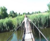 Messalina Dressed in Sun. Outside Outdoor. Nude Milf walks by bridge River. Naturist Nudist Woman from naked woman walking on non nude beach